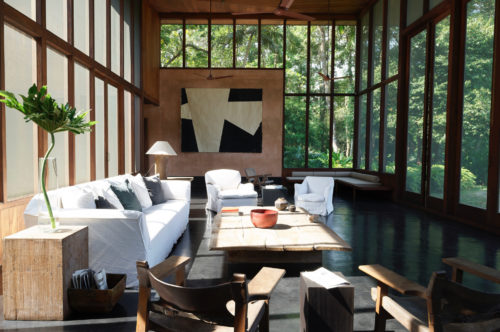 Indoor and outdoor space feel unified in a sitting room in Kerala.