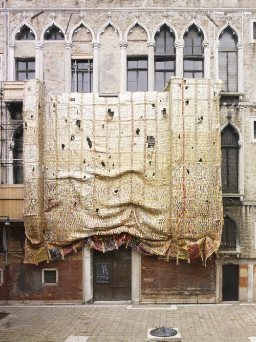 Installation view of El Anatsui's work on the Fortuny façade
