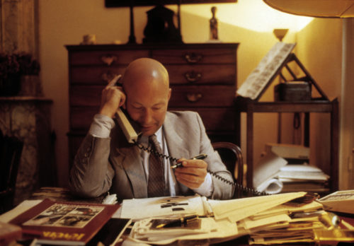 Interior view of Axel working at his desk in the Vlaeykensgang