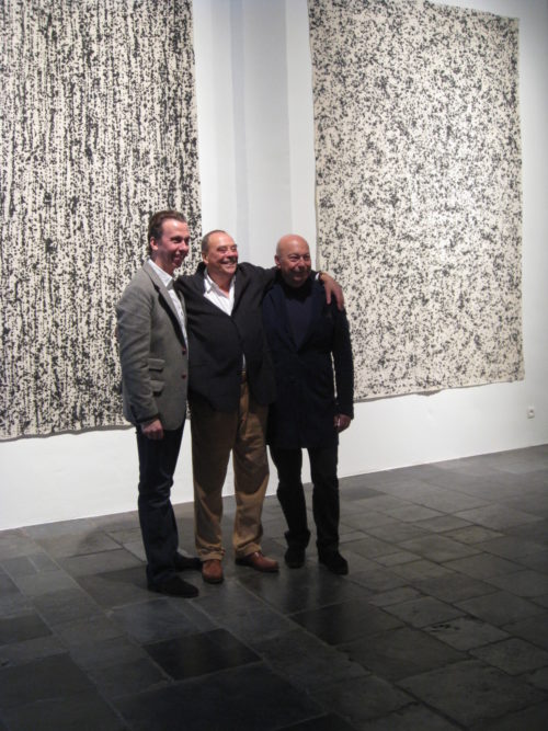 Boris Vervoordt, Günther Uecker, Axel Vervoordt stand if front of Uecker's work at the gallery in 2011.